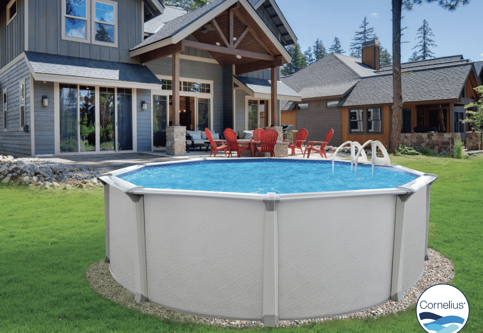 Above-ground PREMIUM POOL-Colombia 54"- 8" Resin Top Rail-SALT FRIENDLY in the backyard of a modern house, with red chairs arranged around a table nearby, surrounded by manicured lawn.